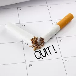 A smashed cigarette on a calendar marking the day for quitting
